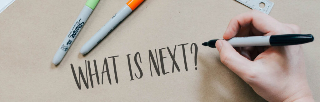 Image of brown craft paper with text "what is next?" written on it